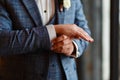 A man in a stylish suit straightens cuffs on his shirt. Shooting of a businessman in a suit. Business concept. Close-up of a man i Royalty Free Stock Photo