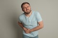 Man suffering from acute appendicitis on light grey background Royalty Free Stock Photo