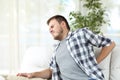 Man suffering back pain at home Royalty Free Stock Photo