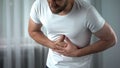 Man suffering bellyache at home, gastritis symptom, peptic ulcer, pancreatitis