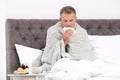 Man suffering from cough and cold in bed Royalty Free Stock Photo