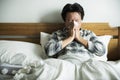 A man suffering from flu sitting in bed Royalty Free Stock Photo