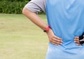 Man suffering from pain in his back injury after sport exercise running jogging Royalty Free Stock Photo