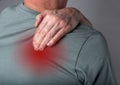 Man suffering from shoulder blade pain. Trigger point. Hand holding shoulder with red point closeup. Back injury. Health Royalty Free Stock Photo