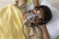 Man suffering from Sleep Apnea, using a CPAP machine Royalty Free Stock Photo