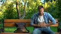 Man suffering stomach ache sitting bench, gastritis problem, food poisoning