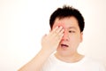 Man suffering from strong eye pain. portrait of young male feeling sick, nose pain and touching painful eyes.