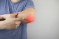 A man suffers from elbow pain. Damaged elbow joint, bone fracture, or sprain. Hand injury and flexion pain concept