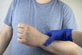 A man suffers from elbow pain. Damaged elbow joint, bone fracture, or sprain. Hand injury and flexion pain concept