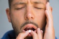 Man suffers from headache. Painkillers to relieve pain.Taking pill from headache
