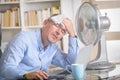 Man suffers from heat in the office or at home Royalty Free Stock Photo