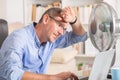 Man suffers from heat in the office or at home Royalty Free Stock Photo