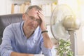 Man suffers from heat in the office or at home Royalty Free Stock Photo