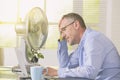 Man suffers from heat in the office or at home Royalty Free Stock Photo