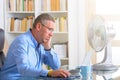 Man suffers from heat in the office or at home Royalty Free Stock Photo