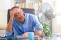 Man suffers from heat in the office or at home Royalty Free Stock Photo