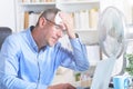 Man suffers from heat in the office or at home Royalty Free Stock Photo