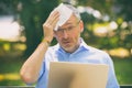 Man suffers from heat while working with laptop