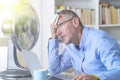 Man suffers from heat in the office or at home Royalty Free Stock Photo