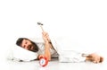 Man suffers in morning, destroys alarm clock, white background. Royalty Free Stock Photo