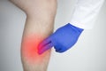 A man suffers from pain in the calves. Stretching the calf muscle, varicose veins, leg cramps, or myositis. Orthopedic doctor