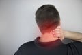 Man suffers from pain in the neck, massages the cervical spine with his hand. Osteochondrosis, hernia, or nerve injury due to