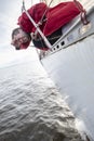 A man suffers from seasickness while walking on a yacht.