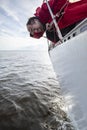 A man suffers from seasickness while walking on a yacht. Royalty Free Stock Photo