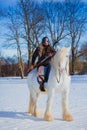 Man in suit of ancient warrior riding big white horse Royalty Free Stock Photo