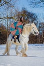 Man in suit of ancient warrior riding big white horse Royalty Free Stock Photo