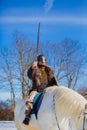 Man in suit of ancient warrior raising his sword