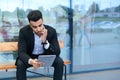 Man in suit arabic puts on sunglasses with tablet near business center Royalty Free Stock Photo