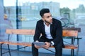 Man in suit arabic puts on sunglasses with tablet near business Royalty Free Stock Photo