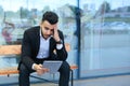 Man in suit arabic puts on sunglasses with tablet near business Royalty Free Stock Photo