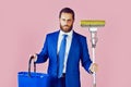 Man in suit with broom and bucket. Funny businessman with happy smiling face holding broom in suit, pure business man Royalty Free Stock Photo