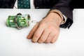 Man in suit chained with handcuffs to money Royalty Free Stock Photo