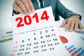 Man in suit with charts and a 2014 calendar Royalty Free Stock Photo