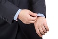 Man in suit correcting a sleeve