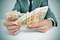 Man in suit with counting euro bills Royalty Free Stock Photo