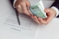 Man in suit counts wad of money before signing contract. Close up of hands with money Royalty Free Stock Photo