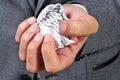 Man in suit with a crumpled piece of paper Royalty Free Stock Photo