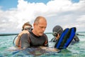 A man in a suit for diving prepares a boy to dive Royalty Free Stock Photo