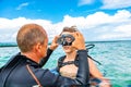 A man in a suit for diving prepares a boy to dive Royalty Free Stock Photo