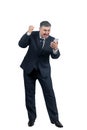 A man in a suit is emotionally talking on the phone, shouting and waving his hands