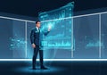 A man in a suit engages with a large, illuminated digital interface displaying various graphs and Royalty Free Stock Photo