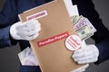 Man in suit with euro and dollar currency in pokets and in white gloves hold paper folder with Paradise Papers and Offshore label