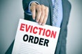 Man in suit with an eviction order