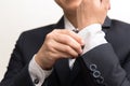 Man in suit fixing his button Royalty Free Stock Photo