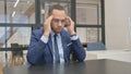 Man in Suit with Headache Sitting in Office Royalty Free Stock Photo