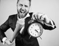 Man suit hold clock in hand and arguing for being late. Business discipline concept. Time management and discipline